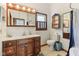 Charming bathroom with vintage vanity, decorative mirrors, toilet, and shower-tub combination at 26735 Six Points Rd, Sheridan, IN 46069