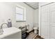 Neat bathroom featuring modern sink, toilet, and white storage at 26735 Six Points Rd, Sheridan, IN 46069