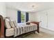 Bedroom features carpeted floors, natural light, and dark wood trim at 26735 Six Points Rd, Sheridan, IN 46069