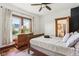 Charming bedroom features warm wood trim, a view to the yard, and an ensuite bathroom at 26735 Six Points Rd, Sheridan, IN 46069