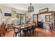 Dining room features a dining table, hardwood floors, piano, and natural lighting through window at 26735 Six Points Rd, Sheridan, IN 46069