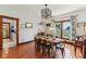 Dining room features a dining table with a chandelier, hardwood floors, and window with a view at 26735 Six Points Rd, Sheridan, IN 46069