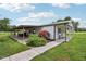 Exterior side view of a home, featuring a covered patio and well-manicured lawn at 26735 Six Points Rd, Sheridan, IN 46069