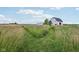 Picturesque farm with a large barn and open fields, showcasing the property's rural charm and agricultural potential at 26735 Six Points Rd, Sheridan, IN 46069
