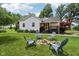 Charming home with a well-manicured lawn and an inviting fire pit area in the front yard at 26735 Six Points Rd, Sheridan, IN 46069