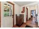 Hallway with wood-look floors, adjacent to bedroom, featuring an 