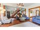 Open-concept living room with hardwood floors, comfortable furniture and an open staircase at 26735 Six Points Rd, Sheridan, IN 46069