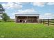 Open-sided shed with hammocks and ample storage space, perfect for relaxation and farm equipment at 26735 Six Points Rd, Sheridan, IN 46069