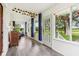 Bright sunroom featuring large windows, wood floors, and blue curtains providing privacy and style at 26735 Six Points Rd, Sheridan, IN 46069