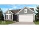 Charming single-story home featuring horizontal siding, a two-car garage, and manicured landscaping at 289 N Bur Oak Dr, Mooresville, IN 46158