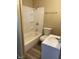 Bright bathroom with white tiled shower and bath, toilet and sink at 3059 5Th E Ave, Indianapolis, IN 46221