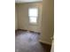 Modest bedroom featuring neutral carpet, natural light, and neutral walls at 3059 5Th E Ave, Indianapolis, IN 46221
