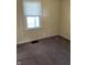 Bedroom featuring a window with blinds and carpeted floor at 3059 5Th E Ave, Indianapolis, IN 46221
