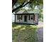 Charming single-story home featuring a covered front porch, green shutters, and a well-maintained lawn at 3059 5Th E Ave, Indianapolis, IN 46221