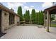 A side angle view of the backyard patio featuring a stone house and a gazebo at 3818 S Creekside Dr, New Palestine, IN 46163