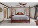 Primary bedroom boasts a four-poster bed, ceiling fan, and neutral carpet at 3818 S Creekside Dr, New Palestine, IN 46163