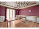 Formal dining room features wood floors, wainscoting, and unique ceiling design at 3818 S Creekside Dr, New Palestine, IN 46163