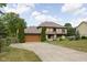 Two-story home featuring stone accents, a two-car garage, landscaping, and a large driveway at 3818 S Creekside Dr, New Palestine, IN 46163