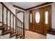 Beautiful foyer with hardwood floors, wood trim, staircase, and a gorgeous front door with sidelights at 3818 S Creekside Dr, New Palestine, IN 46163