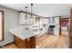 Bright kitchen featuring granite counters, white cabinets, stainless steel appliances, and hardwood floors at 3818 S Creekside Dr, New Palestine, IN 46163