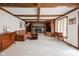 Spacious living room with coffered ceilings, stone fireplace, and built-in cabinets at 3818 S Creekside Dr, New Palestine, IN 46163