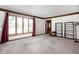 Open living room with a large window, neutral carpet, and custom wood trim at 3818 S Creekside Dr, New Palestine, IN 46163