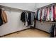 Walk-in closet with wood floor and shelving full of clothes at 3818 S Creekside Dr, New Palestine, IN 46163