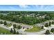 Scenic aerial view of a neighborhood with mature trees and winding streets, with city skyline in the distance at 3920 Oak Harbor Ln, Indianapolis, IN 46237