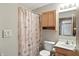 A bathroom with neutral walls, tile flooring, and a shower with a seashell curtain at 3920 Oak Harbor Ln, Indianapolis, IN 46237