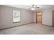 Neutral bedroom with large window, ceiling fan, and closet ready for new occupants at 3920 Oak Harbor Ln, Indianapolis, IN 46237