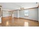 Spacious living area with gleaming hardwood floors and natural light pouring in through a window at 3920 Oak Harbor Ln, Indianapolis, IN 46237