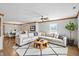 Cozy living room featuring hardwood floors, a ceiling fan, and a large sectional sofa at 3920 Oak Harbor Ln, Indianapolis, IN 46237