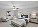 The main bedroom featuring hardwood floors, neutral walls, ceiling fan, and a queen bed at 3920 Oak Harbor Ln, Indianapolis, IN 46237