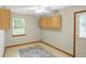 An empty room featuring neutral walls, a ceiling fan, a large window, and light tan floor at 3920 Oak Harbor Ln, Indianapolis, IN 46237