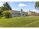 A verdant backyard boasts an immaculate lawn and beautiful greenery, perfect for outdoor enjoyment at 421 E Delaware St, Fortville, IN 46040