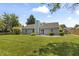 Landscaped backyard with a well-manicured lawn, established greenery, and a cozy patio area at 421 E Delaware St, Fortville, IN 46040