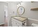 Bathroom showcasing a stylish vanity with granite countertops and round mirror at 421 E Delaware St, Fortville, IN 46040