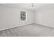 Well-lit bedroom with neutral carpet and large window provides a comfortable retreat at 421 E Delaware St, Fortville, IN 46040