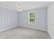 Charming bedroom with blue-striped walls and a closet provides a unique and inviting space at 421 E Delaware St, Fortville, IN 46040
