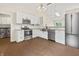 Modern kitchen with stainless steel appliances, white cabinets, and stylish lighting. Laundry in background at 421 E Delaware St, Fortville, IN 46040