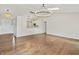 Spacious living room featuring hardwood floors, modern lighting, open layout to the kitchen at 421 E Delaware St, Fortville, IN 46040
