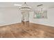 Spacious living room featuring hardwood floors, modern lighting, open layout to the kitchen at 421 E Delaware St, Fortville, IN 46040