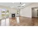 Spacious living room featuring hardwood floors, fireplace, slider door to the yard and a skylight at 421 E Delaware St, Fortville, IN 46040