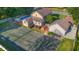 Home with pool, tennis court, and deck from an aerial view at 4224 River Rd, Columbus, IN 47203