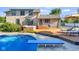 Stunning backyard with diving board pool, hot tub, wooden deck and lounging chairs in sunny, upscale setting at 4224 River Rd, Columbus, IN 47203