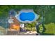 Aerial view of a pool, hot tub, tennis court, and outdoor seating at 4224 River Rd, Columbus, IN 47203