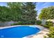 Landscaped yard featuring a fenced-in pool, concrete edging, and some mature trees provides a private retreat at 4224 River Rd, Columbus, IN 47203