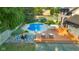 Aerial view of backyard featuring a pool, patio, hot tub and greenery at 4224 River Rd, Columbus, IN 47203