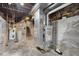 Unfinished basement featuring a furnace and stone walls at 4224 River Rd, Columbus, IN 47203