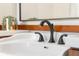 Close up of bathroom sink featuring stylish faucet and decorative plant at 4224 River Rd, Columbus, IN 47203